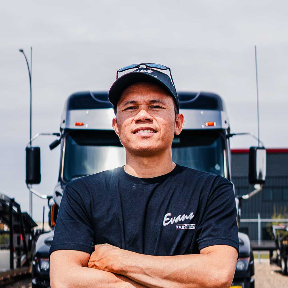 Cool Driver Driver standing in front of truck with arms crossed